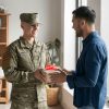 military man receiving gift from another man