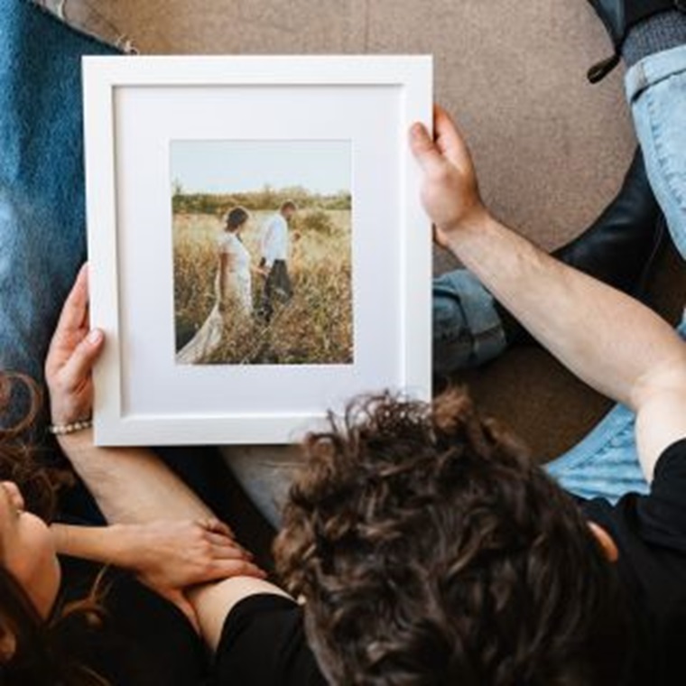 couple looking at a framed picture